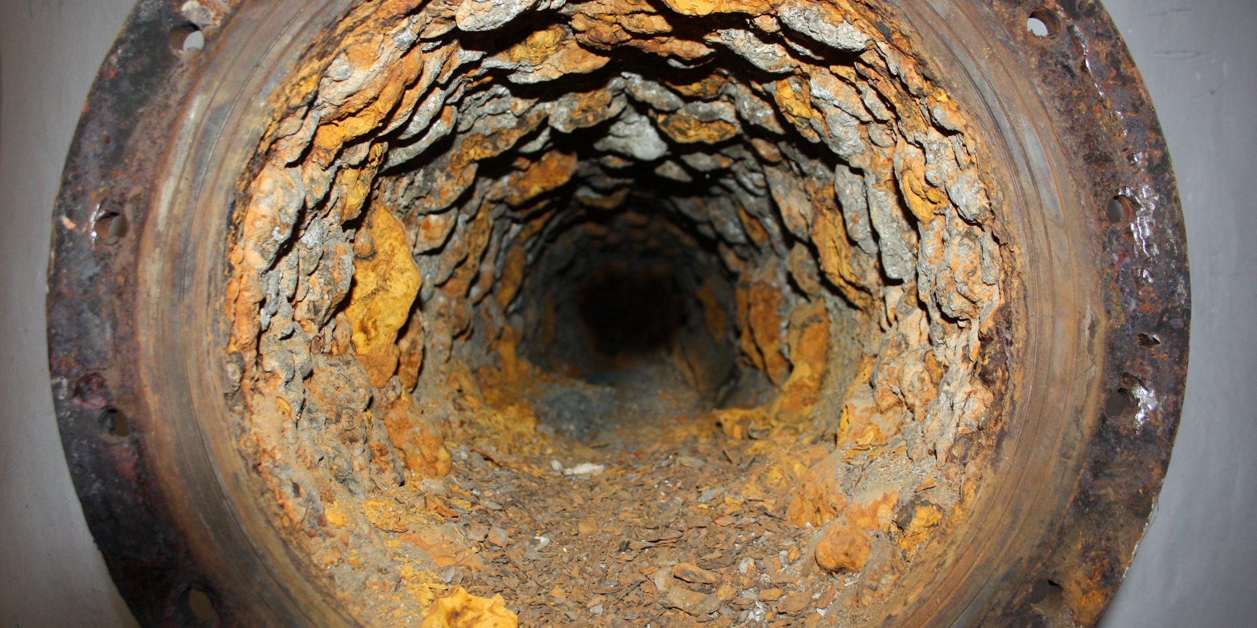 Metal erosion. Pipe in section. abandoned building. Photo for your design.